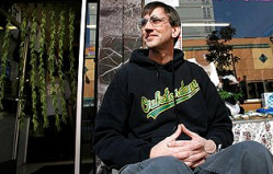 Richard Lee, president of Oaksterdam University, sits in front of the school's gift shop in Oakland. (AP Photo/Dino Vournas)
